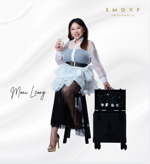 Moni Leong, founder of SMOVF Fragrance, holding one of the bottles beside her case of samples